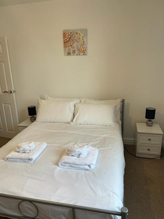 a white bed with towels on top of it at Isandula The Home from Home in Nottingham