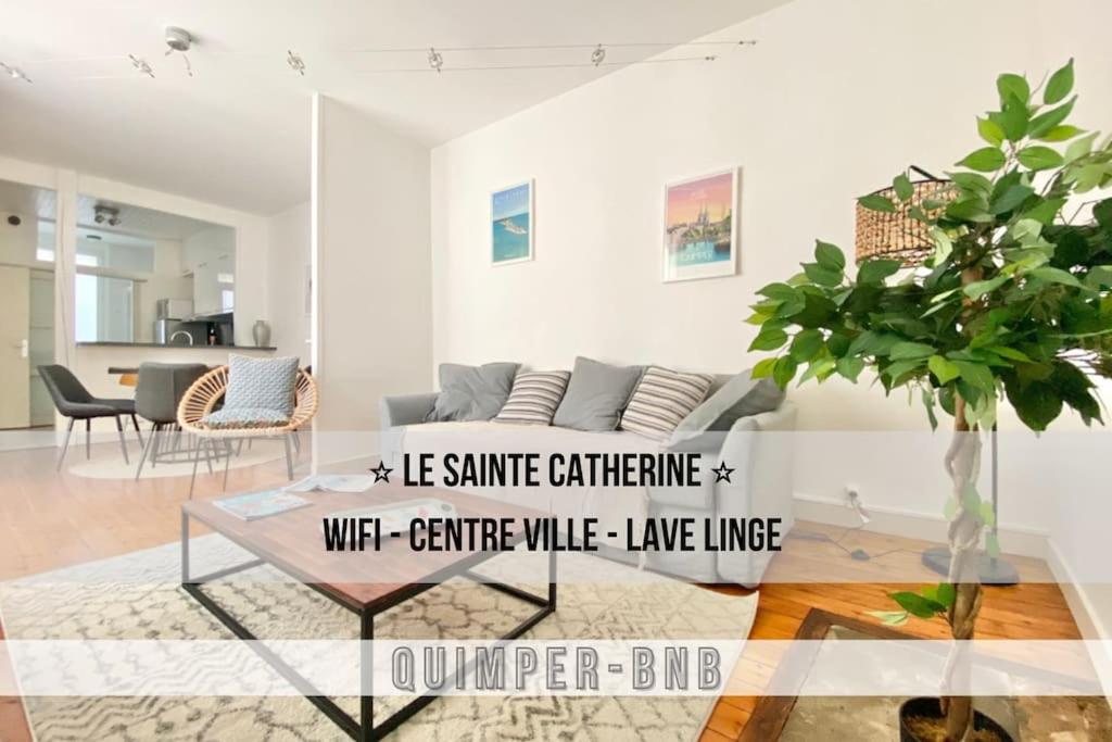 a living room with a couch and a table at LE SAINTE CATHERINE - T2 - Calme - Wifi - Centre ville - Préfecture in Quimper