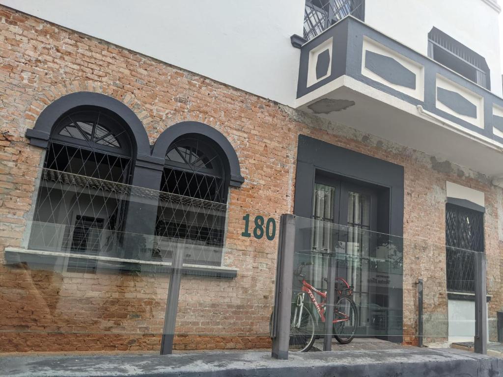 un edificio de ladrillo con una bicicleta en la ventana en Youkoso Hostel en Florianópolis