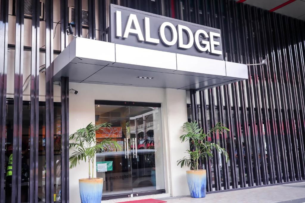a building with a sign on the side of it at Ialodge in Ormoc