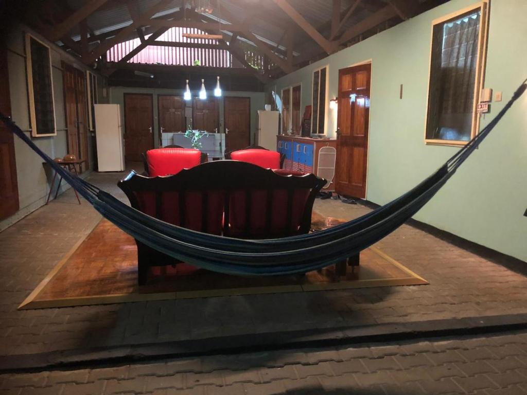 a hammock in the middle of a room at Unu Pikin Guesthouse in Paramaribo