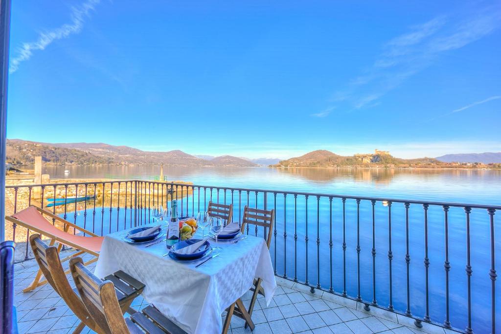 a table on a balcony with a view of the water at Aparthotel Arona - Happy Rentals in Arona