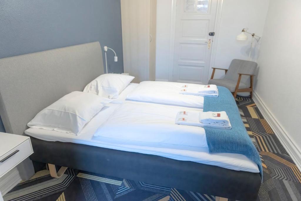 Postel nebo postele na pokoji v ubytování Hotel Harmonien