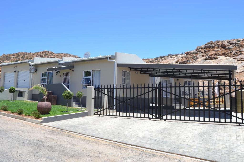 a house with a black gate and a driveway at Chef's@6 in Springbok