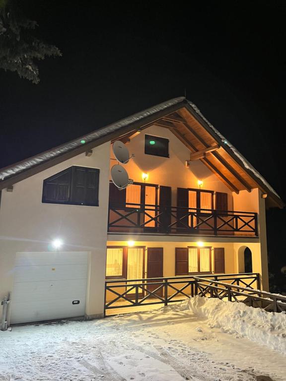 a house with a garage in the snow at night at Villa Grand Jahorina in Jahorina