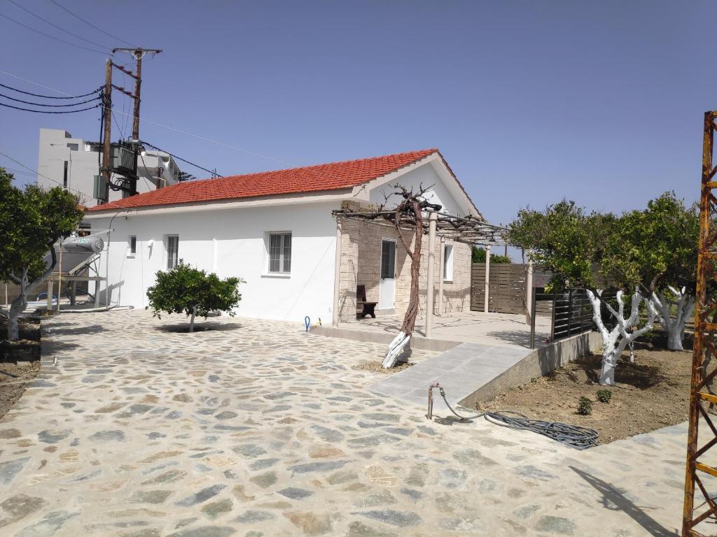 a house with a stone driveway in front of it at FALIRAKI CITRUS GARDEn in Faliraki