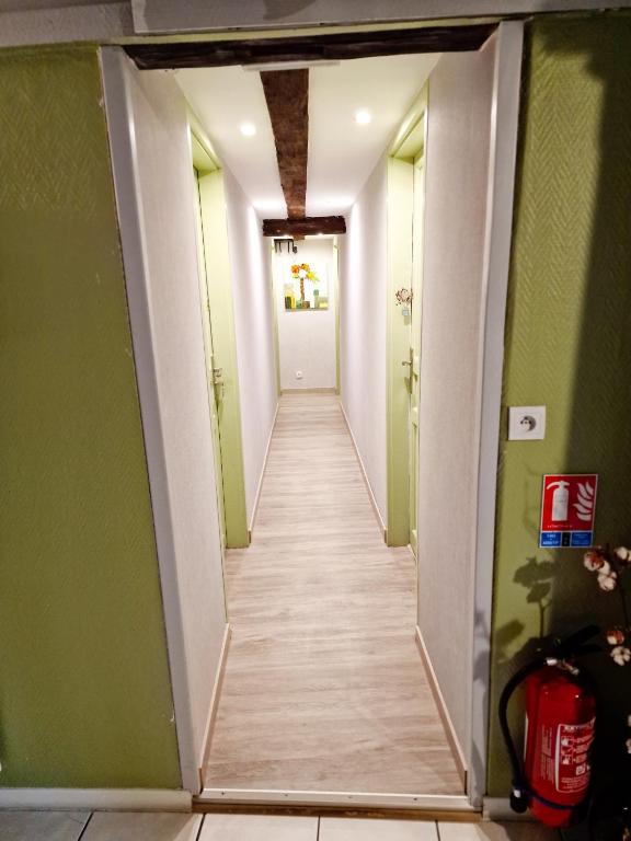 a hallway leading to a room with green walls at Chambres d&#39;hôtes Chez Caroline in Colmar
