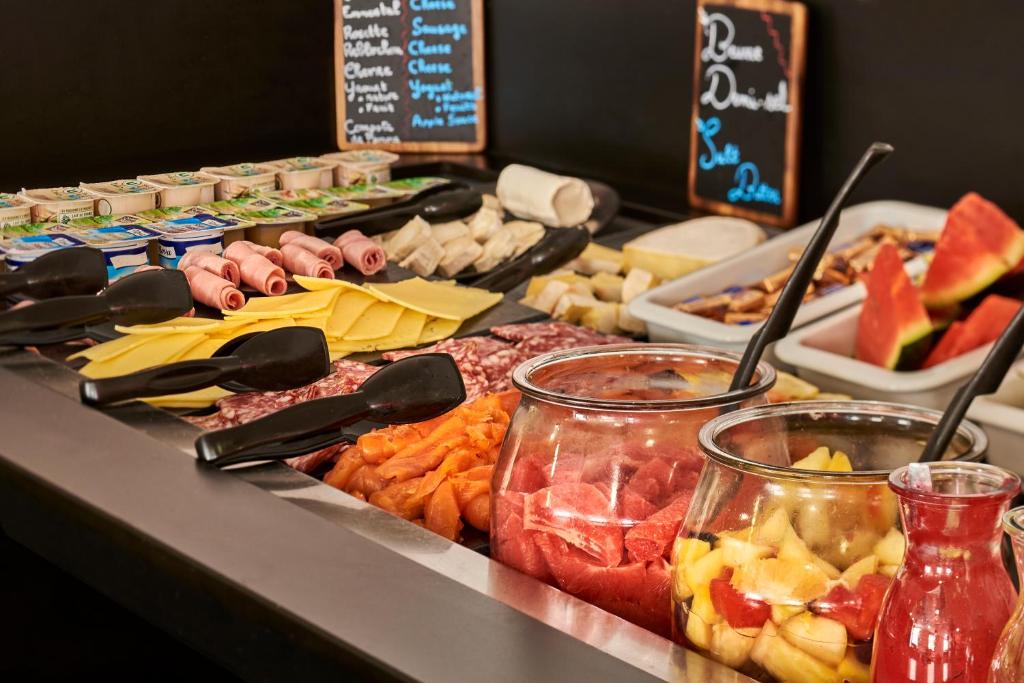 a buffet line with different types of food on a table at Campanile Lyon Centre - Berges du Rhône in Lyon