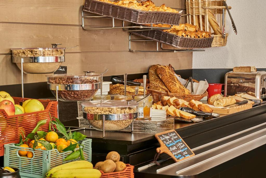 a buffet with baskets of bread and other food at Campanile Lyon Centre - Berges du Rhône in Lyon