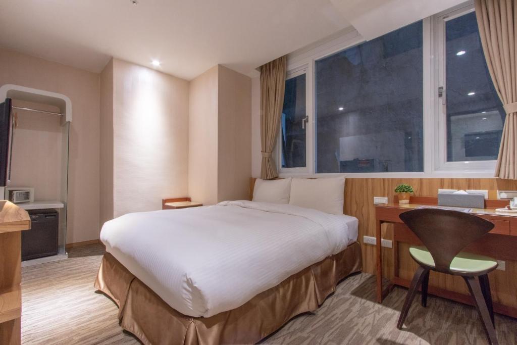 Postel nebo postele na pokoji v ubytování Muzik Hotel - Ximending Xining Branch