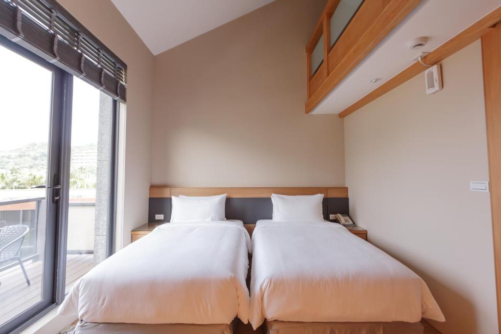 Postel nebo postele na pokoji v ubytování 金漫會館-金瓜石九份景觀民宿-Jien Mount Villas