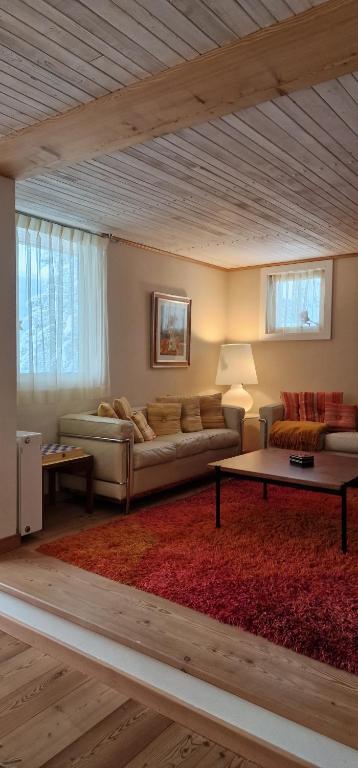 a living room with a couch and a table at Chalet Yvonne in Borca di Cadore