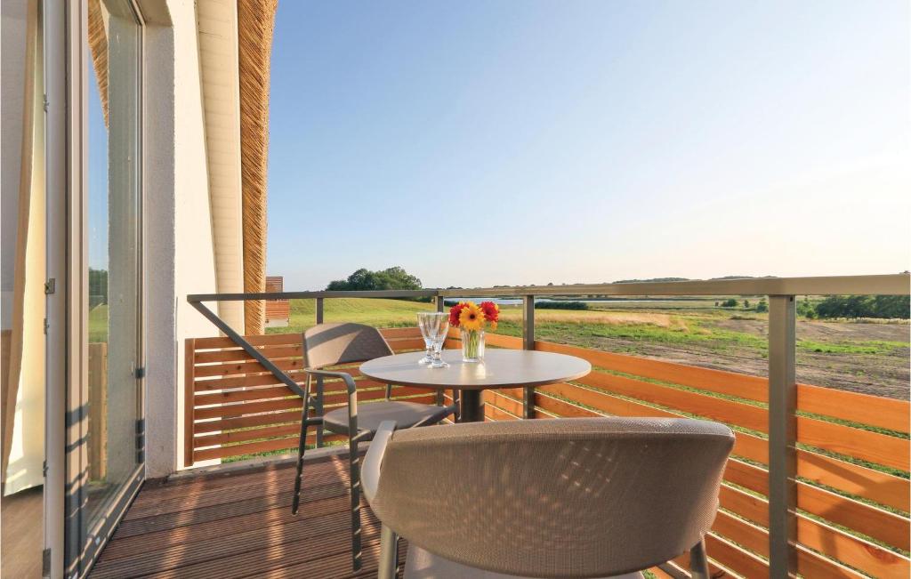 a balcony with a table and chairs with a view at Fewo 30 Putbus-rgen in Wreechen