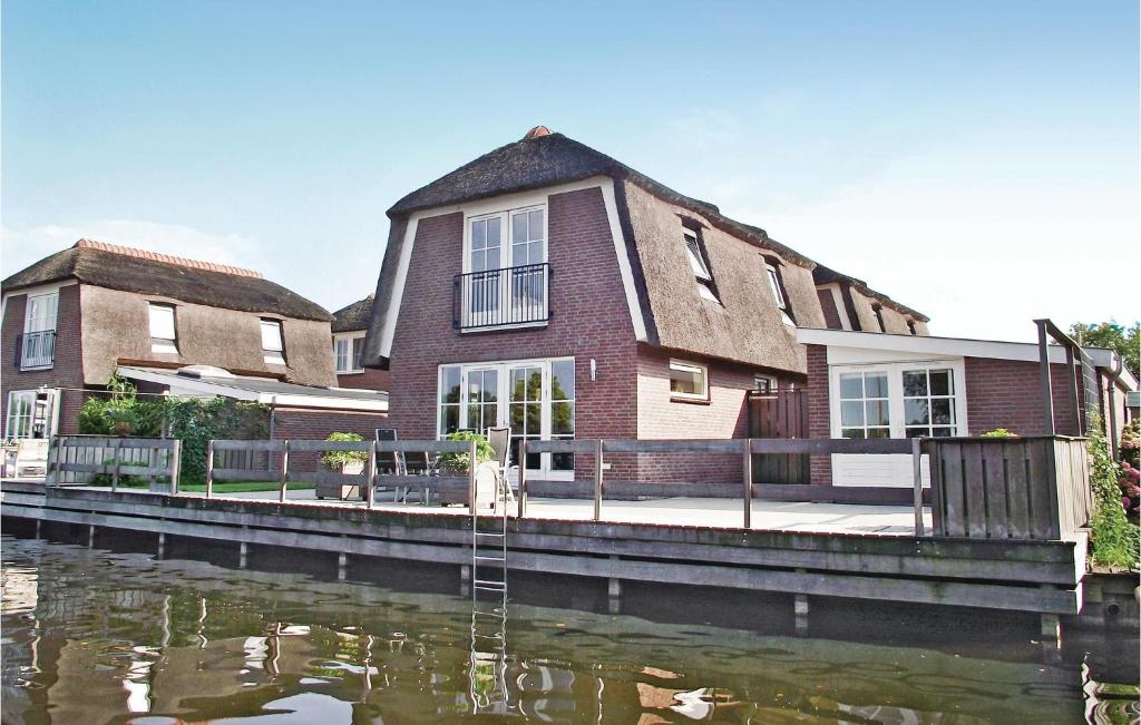 a house next to a river with a house at Beautiful Home In Breukelen With Wifi in Breukelen