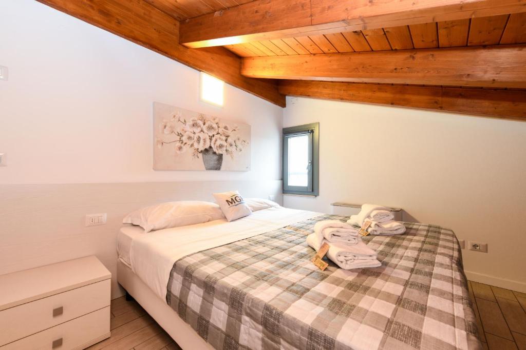 Łóżko lub łóżka w pokoju w obiekcie Borgo Gasparina Family Apartments