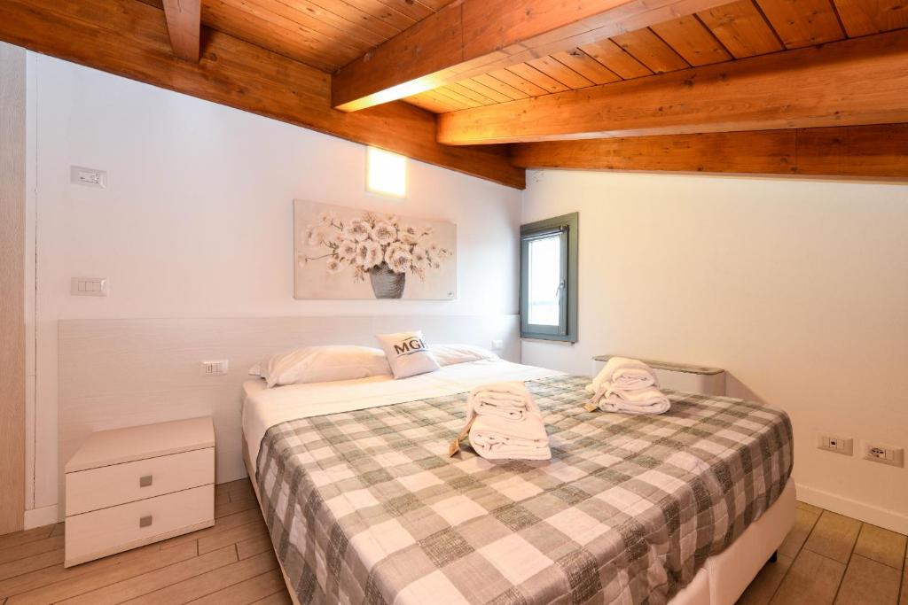 Łóżko lub łóżka w pokoju w obiekcie Borgo Gasparina Family Apartments