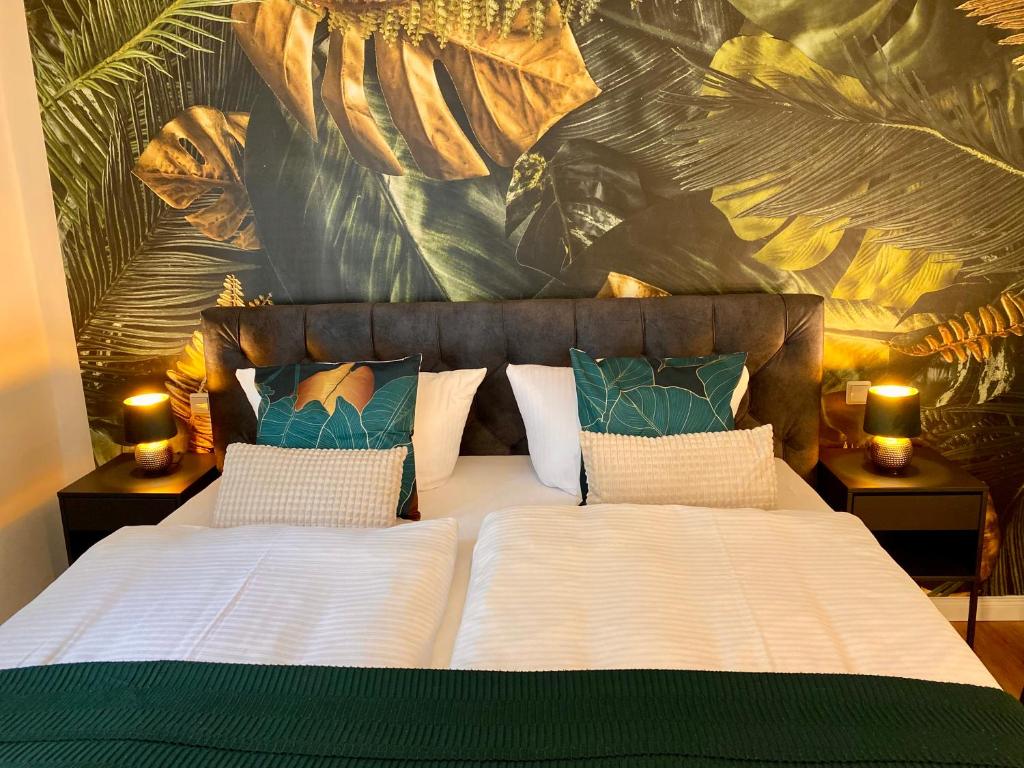 a bedroom with a large bed with two lamps on tables at Traumhaus Wernigerode mit Sauna und Kamin in Wernigerode