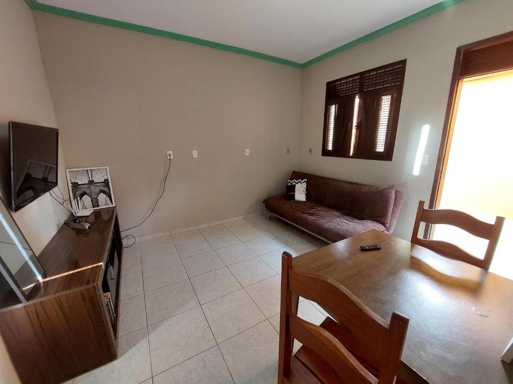 a living room with a couch and a table at Casas 5 min a pé da praia in Natal