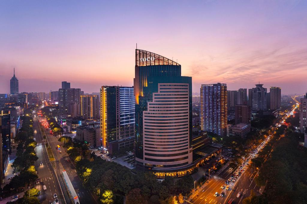 a city skyline at night with a tall building at voco Changzhou Fudu in Changzhou