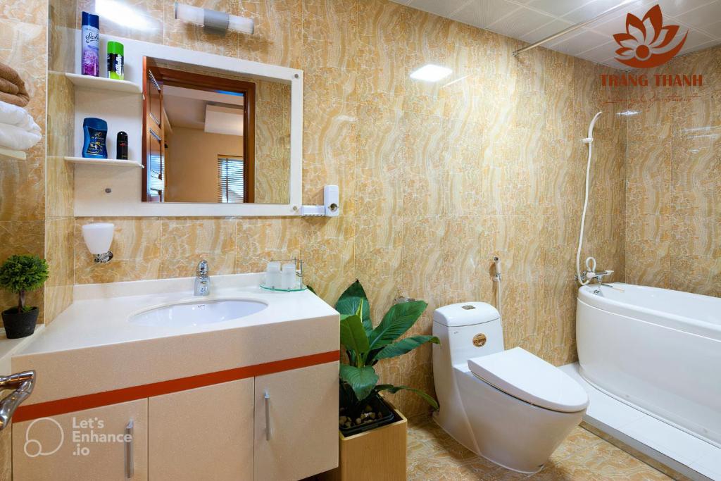 a bathroom with a sink and a toilet and a tub at Trang Thanh Luxury Apartment in Hai Phong