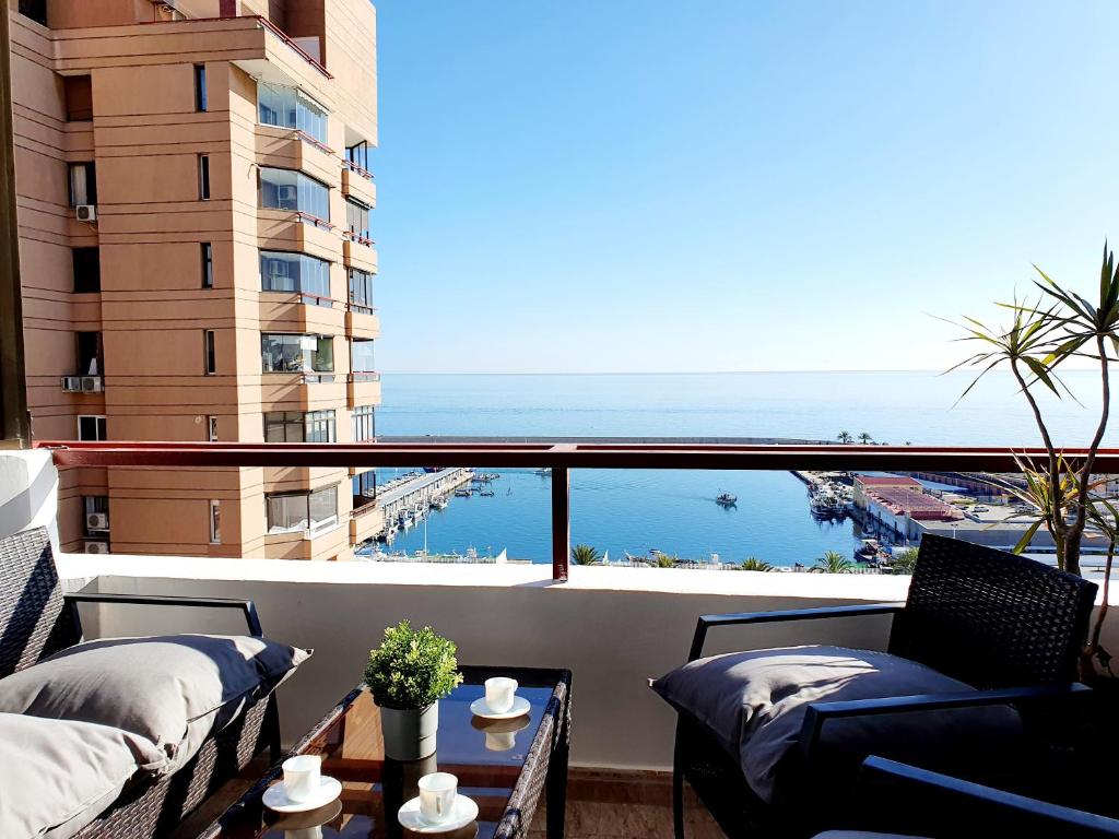 a balcony with two beds and a view of the ocean at Marina View Apartment in Fuengirola