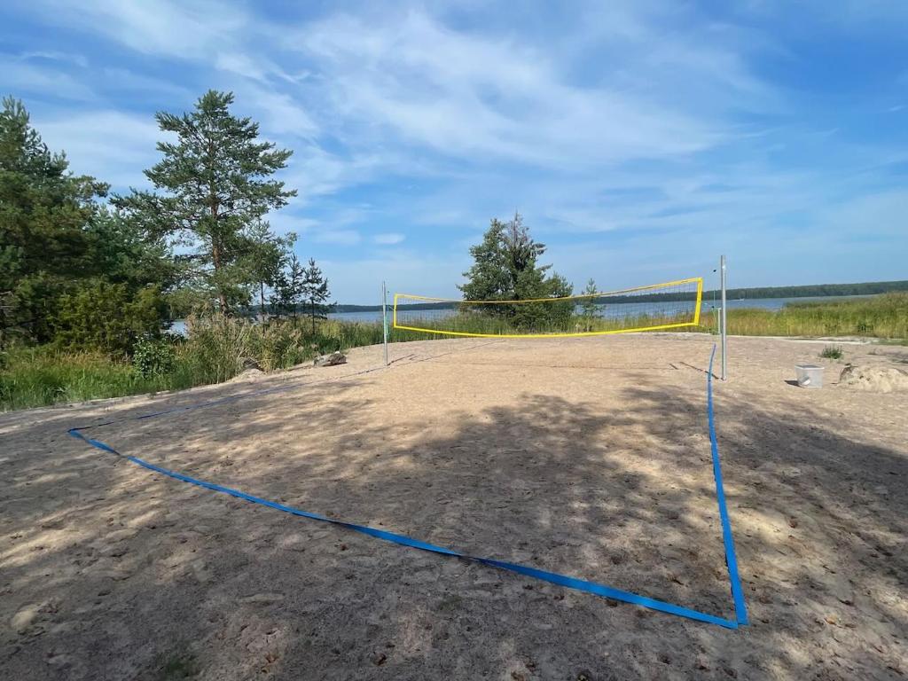 a volleyball court with a net on a beach at Villa Mustikka in Ekenäs