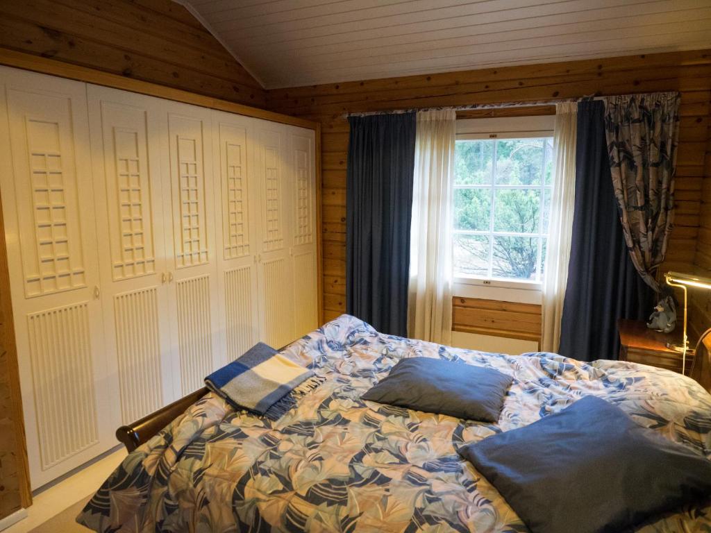 a bedroom with a bed with two pillows on it at Villa Mustikka in Ekenäs