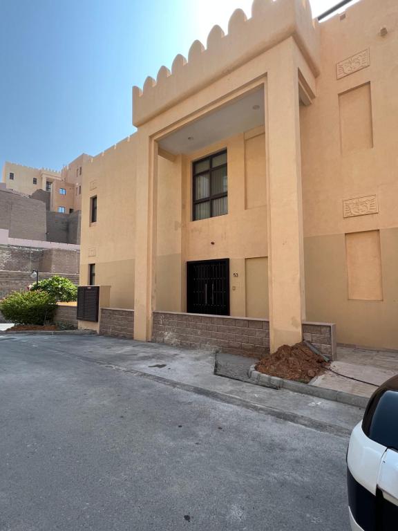 a building on the side of a street at 3 Bed rooms Villa at Mina Alfajer Resort Dibba - Al-Fujairah in Rūl Ḑadnā
