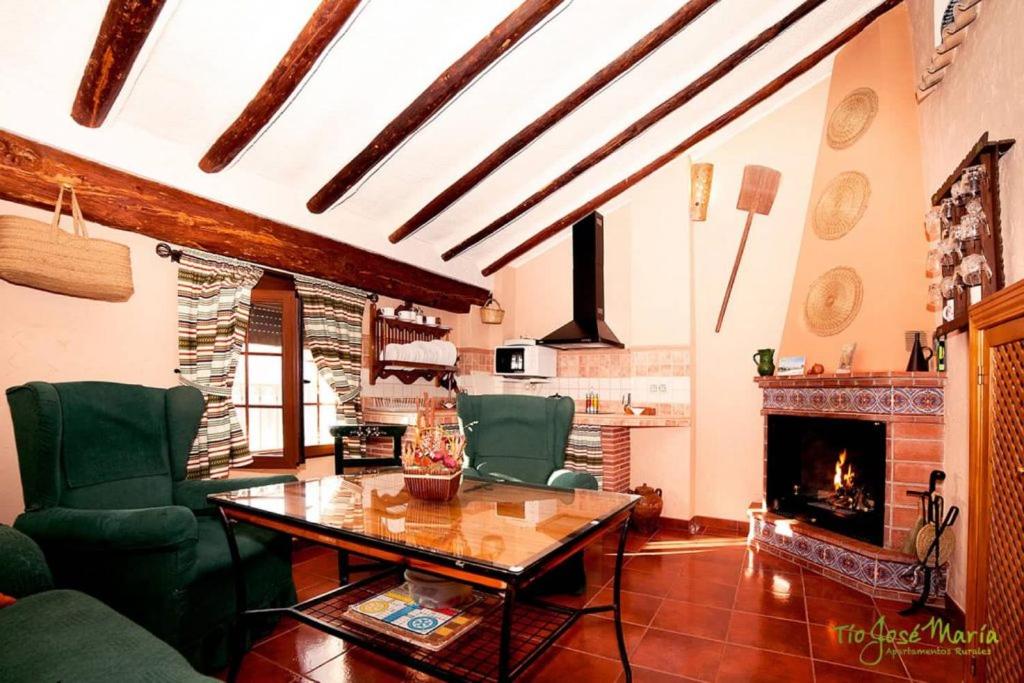 a living room with a table and a fireplace at Apartamentos Tío José María in Hinojares