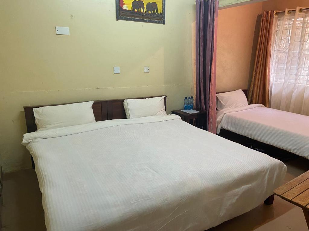 Postel nebo postele na pokoji v ubytování Ranges View Lodge Staycation