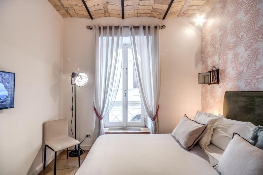 A bed or beds in a room at PgrHome Borgo Vittorio