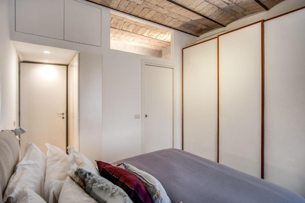 A bed or beds in a room at PgrHome Borgo Vittorio