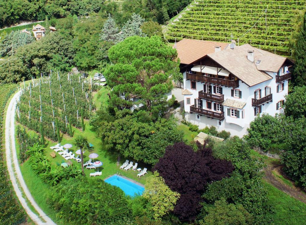 an aerial view of a large house with a swimming pool at Matailerhof in Tirolo