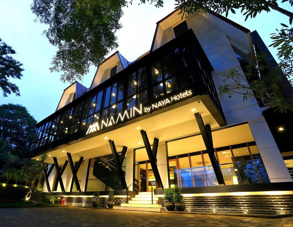 a building with a sign on the front of it at Namin Dago Hotel in Bandung