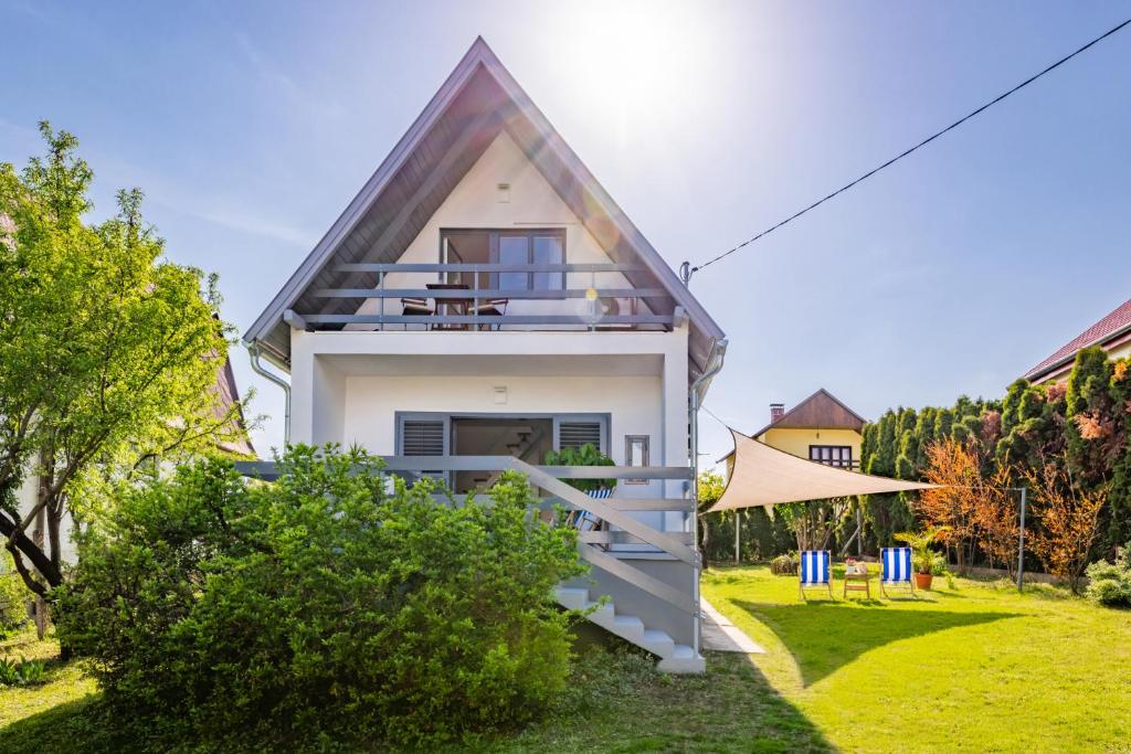 a small house with a pitched roof at Madarász Deluxe Vendégház in Balatonalmádi