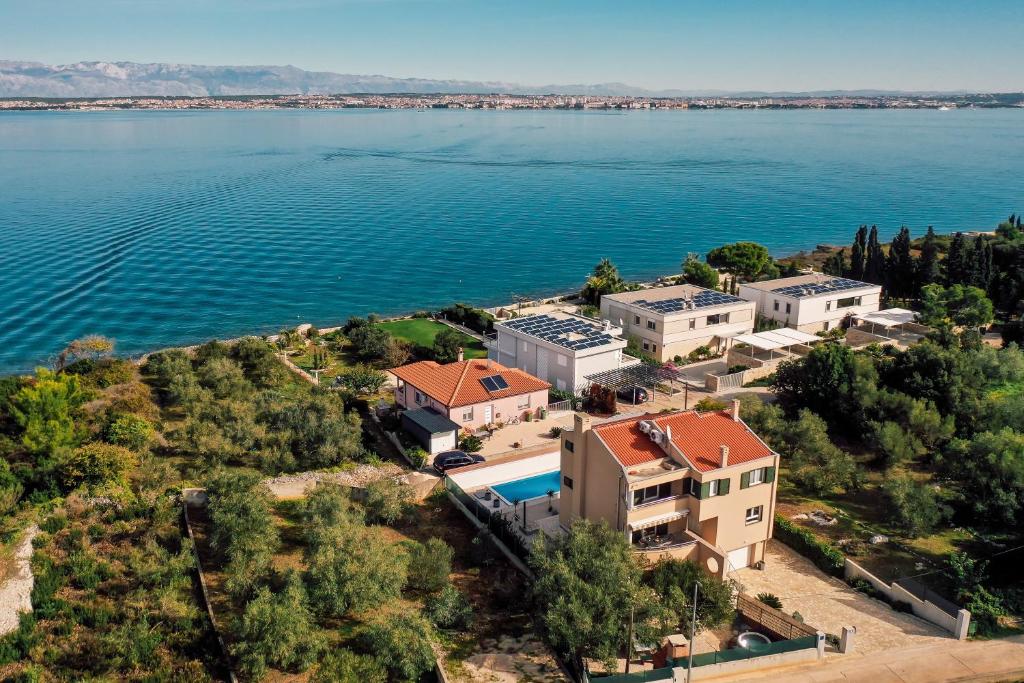 an aerial view of a house on the shore of the water at Villa Frida in Sutomišćica