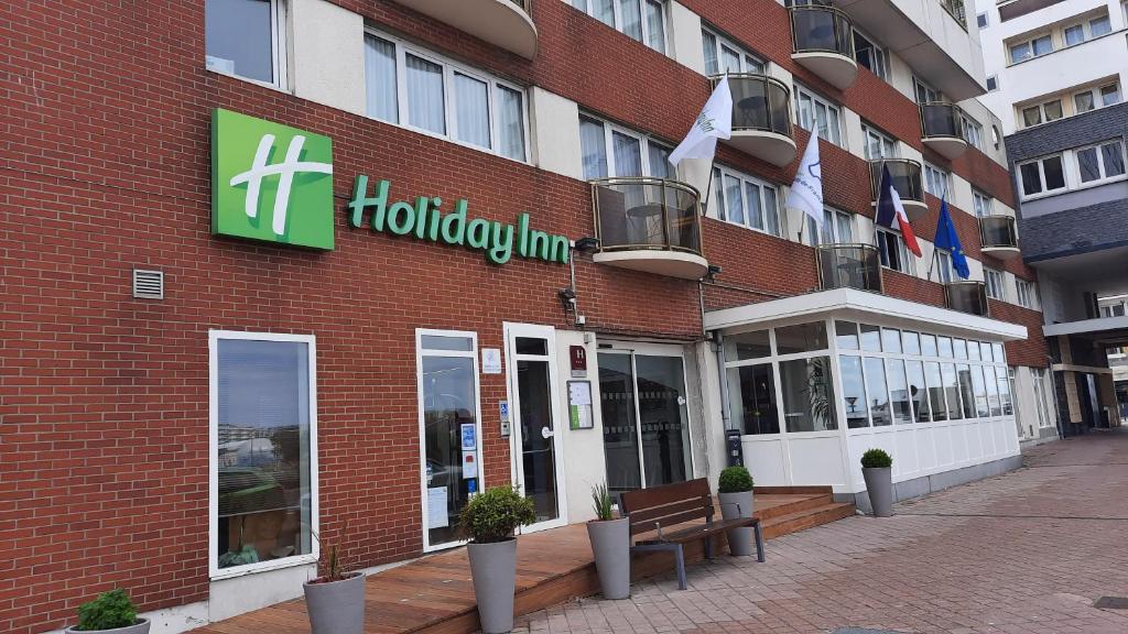a store front of a building with a sign on it at Holiday Inn Calais-Centre, an IHG Hotel in Calais