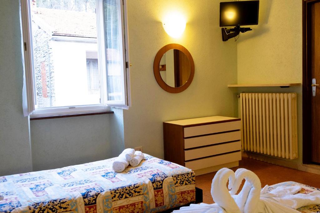 Postel nebo postele na pokoji v ubytování Albergo Ponte di Nava