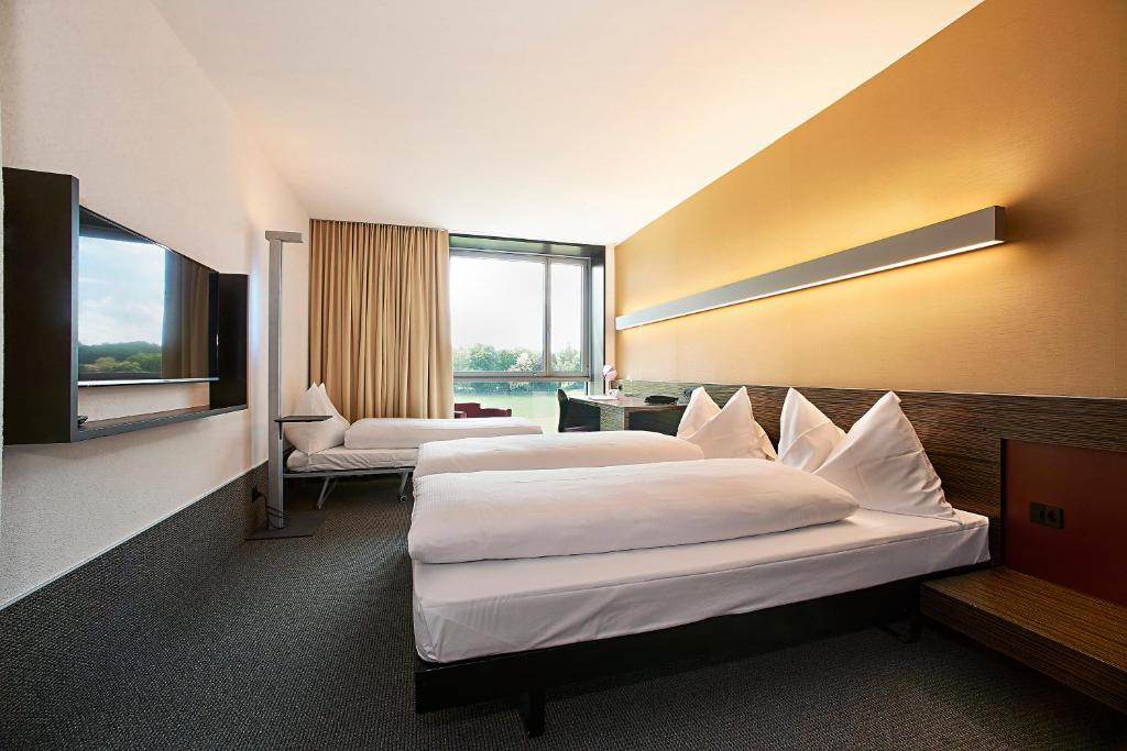 Postel nebo postele na pokoji v ubytování Hotel Ambassador