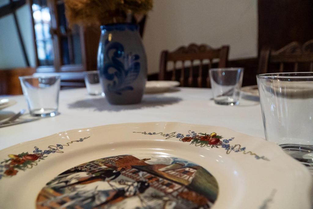 a plate with a picture on it on a table at A la ferme in Kurtzenhouse