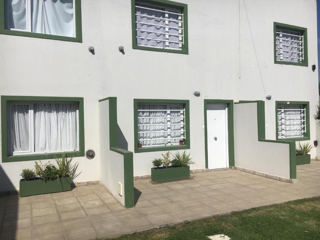 a white building with windows and a door at Las Tortolas in Tandil