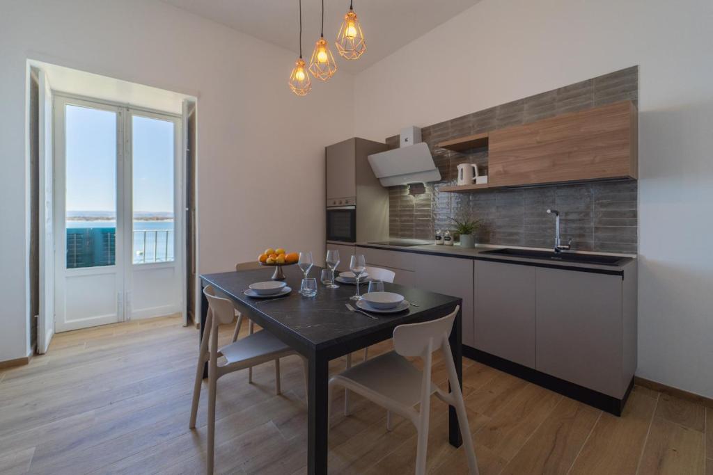 A kitchen or kitchenette at Ortigia Superior Sea View Apartment near Duomo