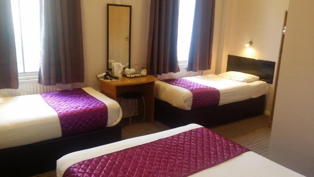 Postel nebo postele na pokoji v ubytování Arriva Hotel
