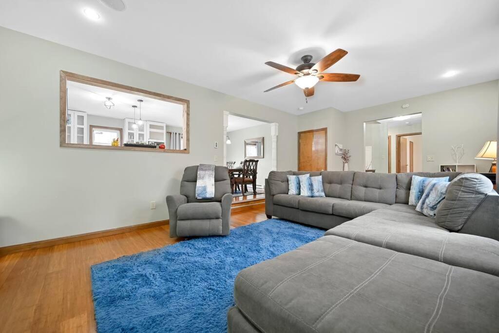 a living room with a couch and a blue rug at Newly Renovated! GAME ROOM! Private Bathrooms in Tobyhanna