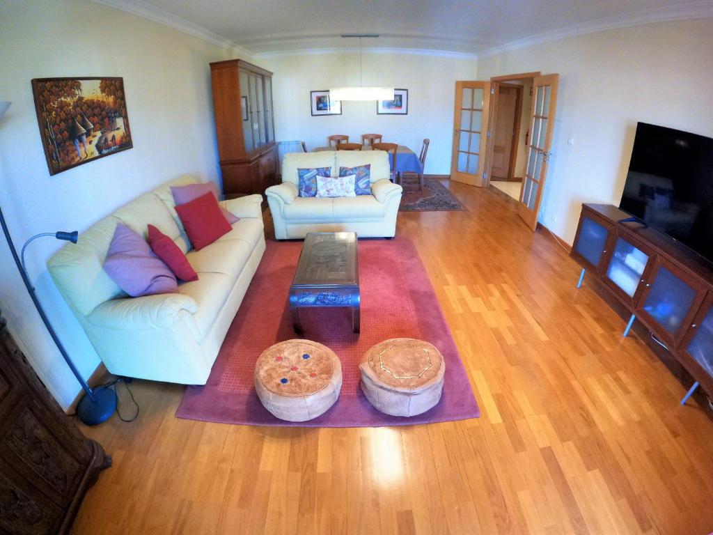 ein Wohnzimmer mit einem Sofa und einem Tisch in der Unterkunft Lisbon 2 bedroom apartment with balcony in Algés in Algés