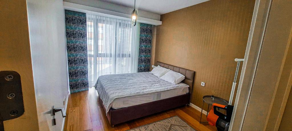 a small bedroom with a bed and a window at Ultra Lux Residence Flat-Great LocationB1 in Istanbul