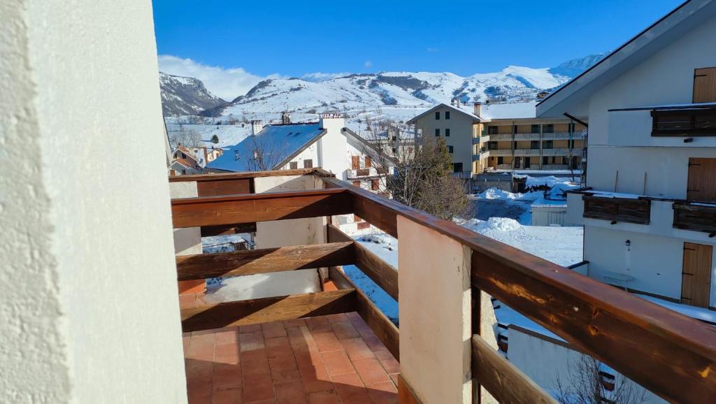 einen Balkon mit schneebedeckten Bergen im Hintergrund in der Unterkunft Appartamento Bucaneve in Ovindoli