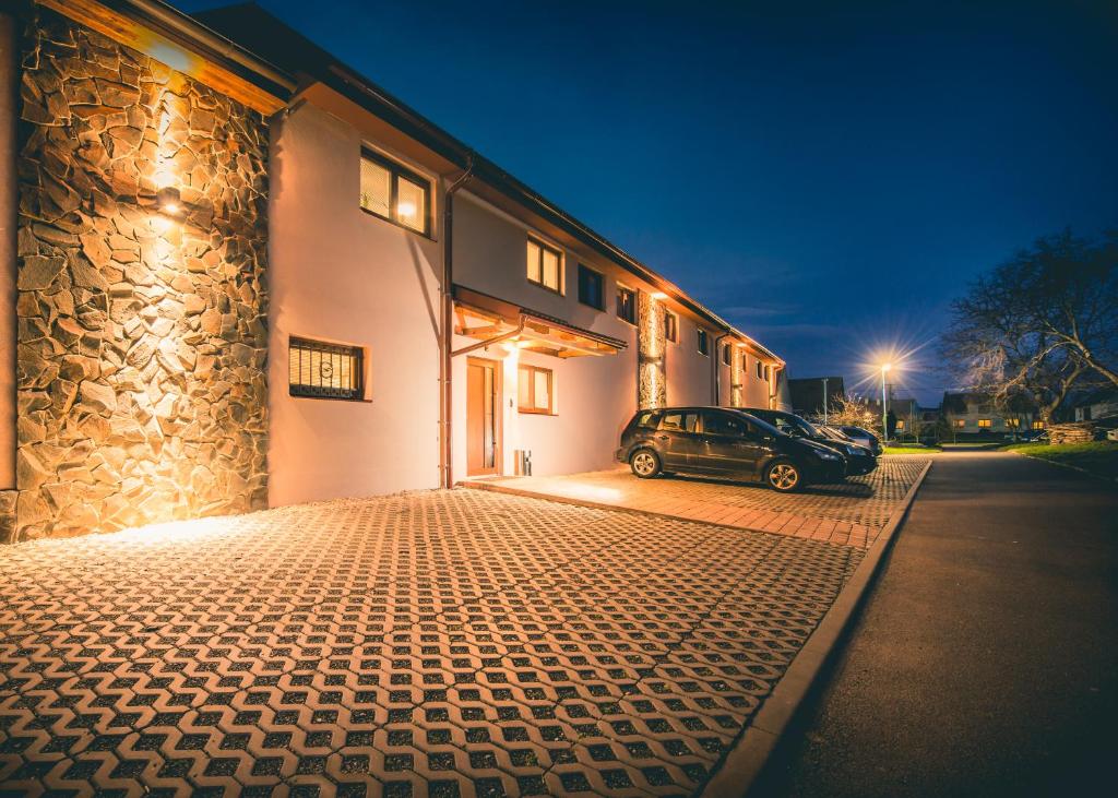 a car parked in front of a building at night at Penzion Víno Hruška Blatnička in Blatnička