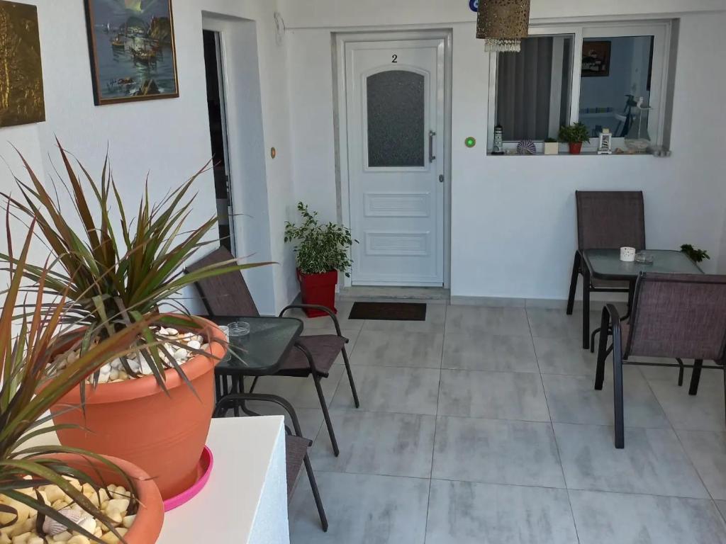 a room with chairs and a table with plants at House Blerina in Sarti