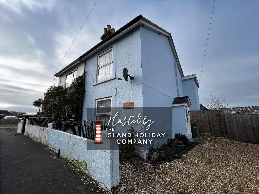 a small house with a sign in front of it at Kema Cottage in East Cowes